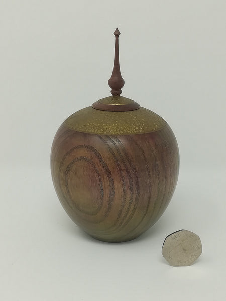 Turned wood ash jar with gold coloured detail and purple heart finial by Roderick Evans.
